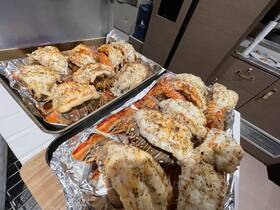 A delicious spread of grilled lobster tails prepared onboard, perfect for a gourmet dining experience while enjoying time on the water.