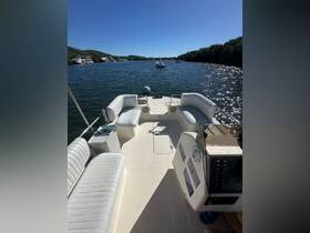 A well-appointed interior view of a boat's helm and seating area, showcasing comfortable seating and a clean layout, perfect for relaxing on the water.