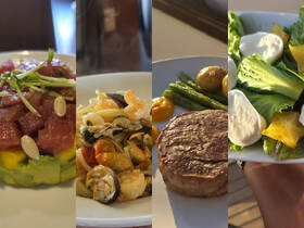 A delicious spread of gourmet dishes featuring fresh seafood, steak, and salad, perfect for onboard dining experiences.