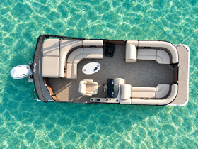 Aerial view of the spacious interior of a pontoon boat, showcasing comfortable seating and a helm, perfect for relaxing on the water.
