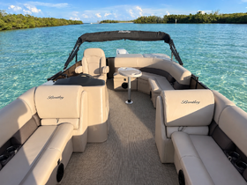 Interior view of a luxurious Bentley pontoon boat, showcasing comfortable seating and a stylish layout, perfect for relaxing on the water.