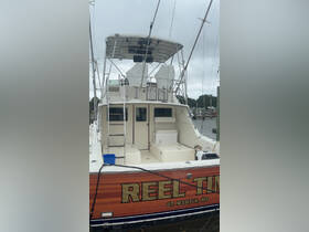 The interior of the 'Reel Time' boat showcases a spacious helm area, perfect for fishing trips or leisurely cruises. The clean design and ample seating make it an ideal choice for comfort on the water.