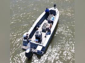 A lively group enjoys a fishing trip on a boat, showcasing the fun of on-water activities with family and friends.