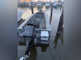 A detailed view of a camouflaged boat docked at a marina, showcasing its sleek design and equipment — perfect for fishing or recreational outings.