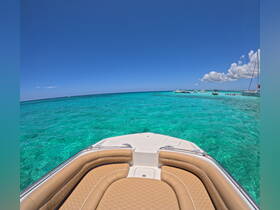 A stunning view from the bow of a boat, showcasing the vibrant turquoise waters and a clear blue sky — perfect for a day of adventure on the water.