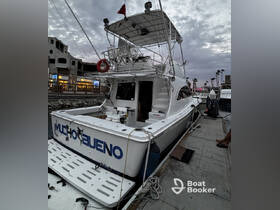A sleek yacht named 'Mucho Bueno' docked at the marina, showcasing its impressive design and ready for the next adventure.