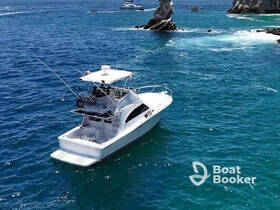 An aerial view of a sleek yacht cruising through vibrant blue waters, showcasing its elegant design and perfect for luxury outings.