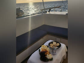A beautifully arranged charcuterie platter featuring an assortment of cheeses, crackers, and grapes, perfect for enjoying while sailing at sunset.