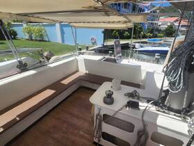 Interior view of a spacious boat cabin featuring comfortable seating and helm area, perfect for relaxing while cruising.