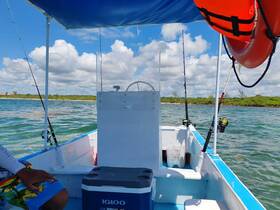 A view of the interior of a fishing boat, showcasing the helm and fishing gear, perfect for a day out on the water.