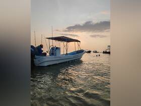 A fishing boat is docked in shallow waters at sunset, showcasing its structure and the serene atmosphere of a day on the water.