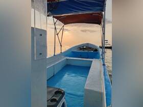 Interior view of a boat showcasing its blue seating area and helm, perfect for a relaxing day on the water.