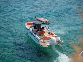 A sleek speedboat navigates through crystal-clear waters, showcasing its stylish design and inviting seating, perfect for a day of adventure on the sea.
