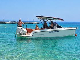 A family enjoys a sunny day on the water aboard a rental boat, showcasing a perfect summer getaway with clear turquoise waters.