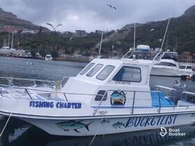 A fishing charter boat named 'Bucketlist' docked in a serene harbor, showcasing its vibrant design and readiness for adventure on the water.