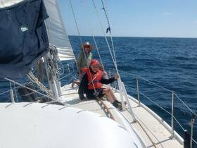 A family enjoys a sailing adventure on the open ocean, capturing the joy of time spent together on the water.