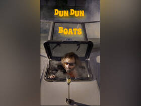 A man peeks out from the cabin of a boat, showcasing the interior space and helm area, perfect for exploring the waters.