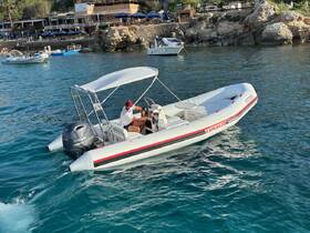A speedboat named 'Explorer' is seen on the water, with a person at the helm, showcasing the perfect vessel for coastal adventures.