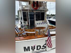 A cozy interior view of a boat featuring comfortable seating and a well-equipped helm, perfect for relaxing and enjoying time on the water.