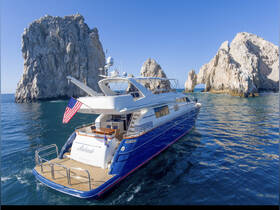 A stunning aerial view of a luxurious yacht anchored near iconic rock formations, showcasing the beauty of the coastline and perfect for scenic cruises.