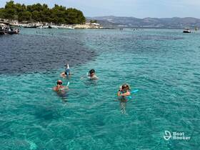 A group of snorkelers enjoys the crystal-clear waters, showcasing the perfect setting for underwater exploration and fun in the sun.
