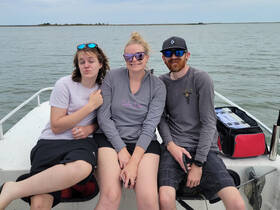 A fun group of friends enjoys a day on the water, capturing memories aboard their boat. Perfect for social outings and adventures on the lake.
