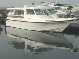 A sleek tourism boat named 'ABU AL KAMAL-5' docked at the marina, reflecting beautifully on the calm waters — perfect for exploring coastal destinations.