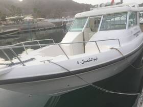 A sleek boat docked at the marina, showcasing its design and structure against a serene water backdrop.