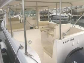 Interior view of a spacious boat cabin featuring comfortable seating, ideal for relaxing while enjoying a day on the water.