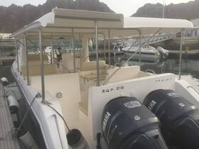 Interior view of a spacious boat cabin featuring comfortable seating and a helm, ideal for leisurely outings on the water.