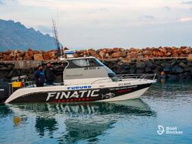 Two men stand aboard a fishing charter boat in Gordon's Bay, ready for a deep-sea adventure. The scenic backdrop of rocky shores adds to the excitement of the fishing experience.