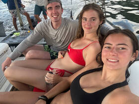 A group of friends enjoys a fun day on the water, capturing smiles and camaraderie aboard a boat — perfect for summer adventures and memorable outings.