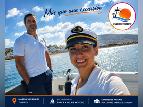 A captain and crew member pose for a selfie aboard a boat in Tenerife, showcasing the beautiful scenery and inviting atmosphere for excursions.