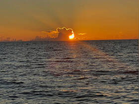 A stunning sunset over the ocean, casting vibrant colors across the sky and water — a perfect backdrop for evening boat trips and romantic getaways.