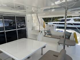 A spacious and modern interior of a boat featuring a dining area and comfortable seating, perfect for relaxing while enjoying the views.