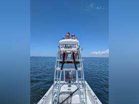 Two friends enjoy a sunny day on the water aboard the 'Run and Gun' charter boat, showcasing the perfect setting for a fun fishing adventure.