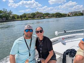 A happy couple enjoys their time on a charter boat, capturing the essence of a perfect day on the water.