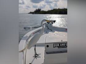 A graceful egret perches on the bow of a boat, showcasing the serene beauty of wildlife encounters on the water.