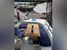 A cozy interior view of a boat's dining area featuring comfortable seating and a wooden table, perfect for relaxing meals on the water.