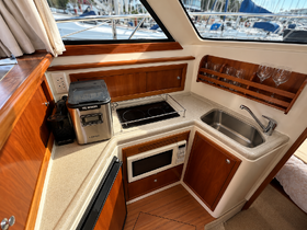 A well-equipped boat kitchen featuring an ice maker, stove, and sink, perfect for preparing meals while on the water.
