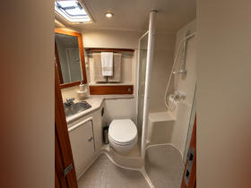 A well-appointed boat bathroom featuring a shower, toilet, and sink, showcasing the comfort and convenience of onboard amenities.