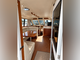 Interior view of a luxurious boat cabin featuring a spacious dining area and comfortable seating, perfect for relaxing and entertaining while on the water.
