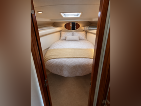 Cozy cabin interior featuring a comfortable bed with elegant decor, perfect for relaxing on a boat getaway.