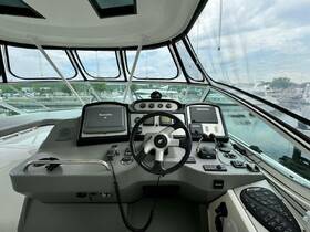 A detailed view of the helm and console area inside a boat, showcasing the navigation equipment and controls, ideal for boating enthusiasts.