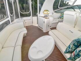 A stylish and comfortable interior of a boat featuring plush seating and a cozy lounge area, perfect for relaxing while enjoying the scenic views.