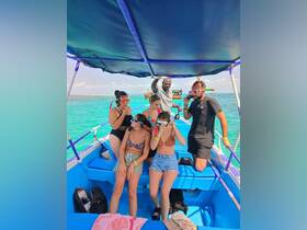 A lively group prepares for snorkeling on a vibrant boat, showcasing the excitement of ocean adventures and group fun.