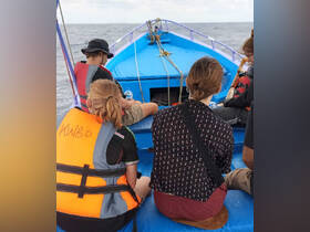 A group of individuals enjoys a boat ride, showcasing the camaraderie and adventure of on-water activities. Perfect for highlighting group outings and marine experiences.
