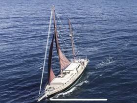 A stunning aerial view of a sailboat gracefully navigating through open waters, showcasing its elegant design and the beauty of sailing.