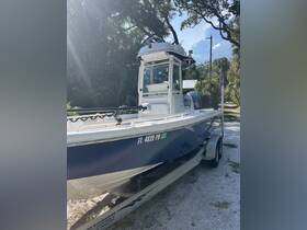 A sleek center console boat is showcased in a sunny setting, perfect for fishing or day cruising. The boat is docked and ready for adventure.