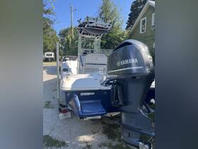 A detailed view of the back of a center console boat featuring a powerful Yamaha engine, showcasing its sleek design and functionality.